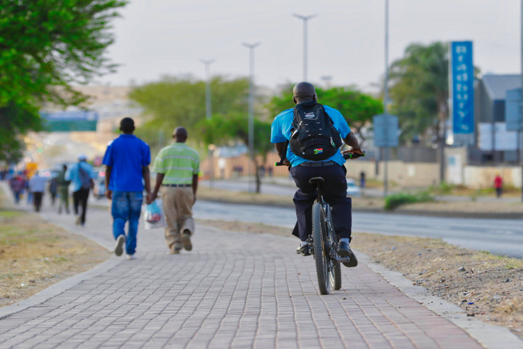 Man riding his bicycle on side walk